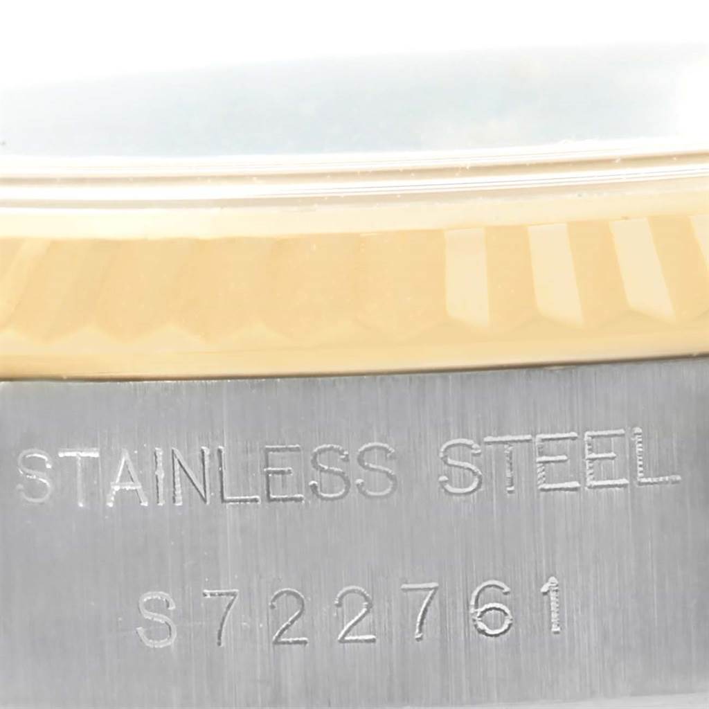 This image shows a close-up of the serial number and part of the stainless steel and gold bezel of a Rolex Datejust 69173 Women's Stainless Steel Champagne Dial 69173 Women's Stainless Steel Champagne Dial watch.