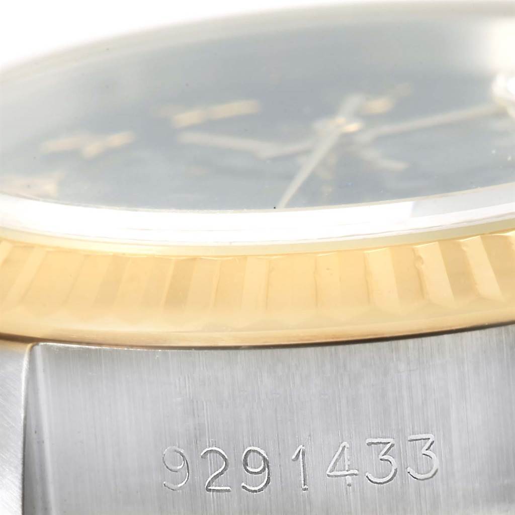 The image shows a close-up angle of the Rolex Datejust 69173 Women's Stainless Steel Black Dial 69173 Women's Stainless Steel Black Dial watch, highlighting the bezel, crystal, and a portion of the serial number.