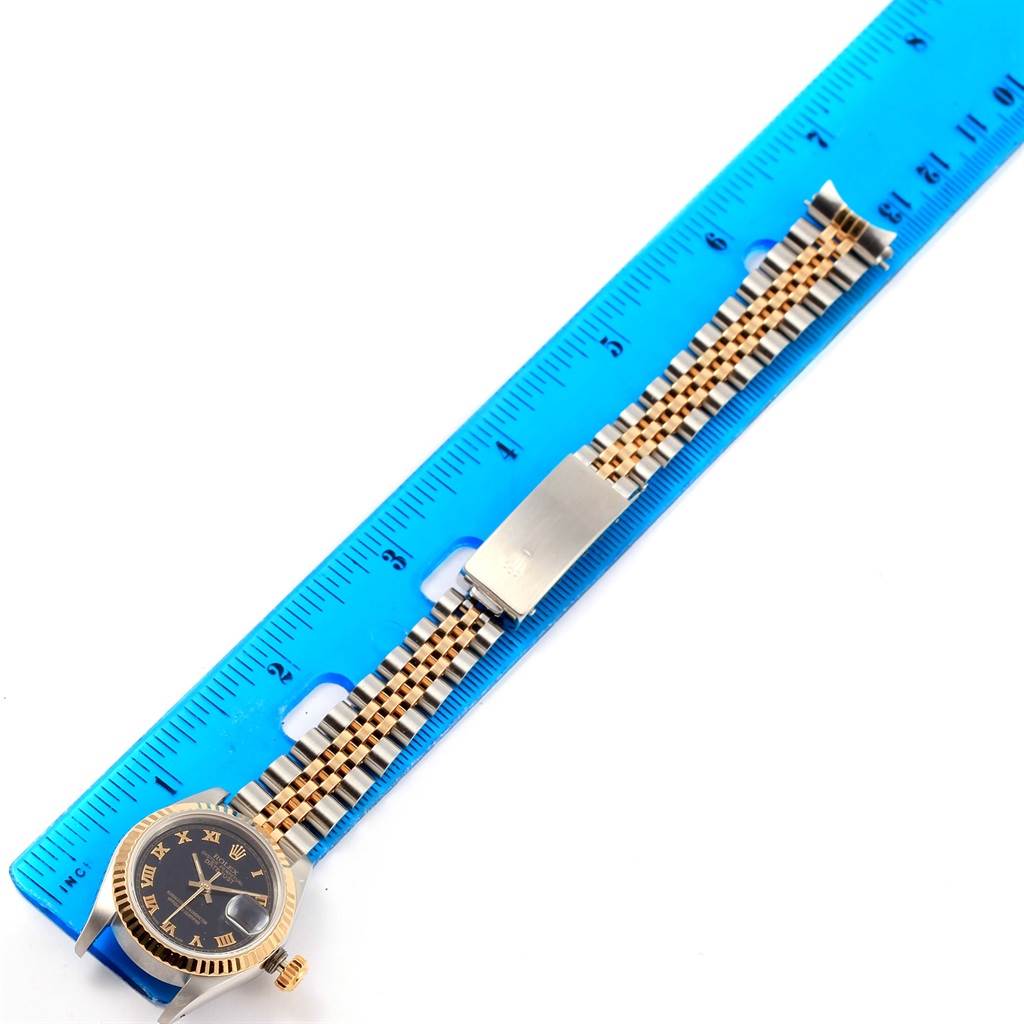 The image shows a Rolex Datejust 69173 Women's Stainless Steel Black Dial 69173 Women's Stainless Steel Black Dial watch and its bracelet measured against a blue ruler from an overhead angle.