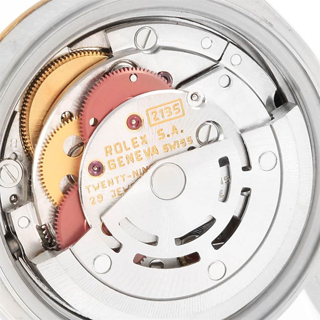 The image shows a close-up of the Rolex Datejust 69173 Women's Stainless Steel Black Dial 69173 Women's Stainless Steel Black Dial watch's internal mechanism, highlighting the movement parts and gears.
