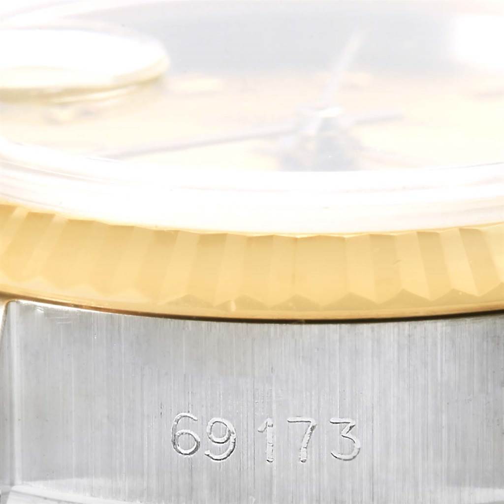 Close-up of a Rolex Datejust 69173 Women's Stainless Steel Champagne Dial 69173 Women's Stainless Steel Champagne Dial watch showing the bezel and part of the case with the model number 69173 engraved.
