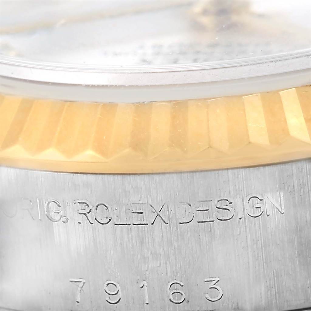 This image shows a close-up of the case and bezel of a Rolex Datejust 79163 Women's Steel and Gold (two tone) Silver Dial 79163 Women's Steel and Gold (two tone) Silver Dial watch, focusing on the model number inscription.