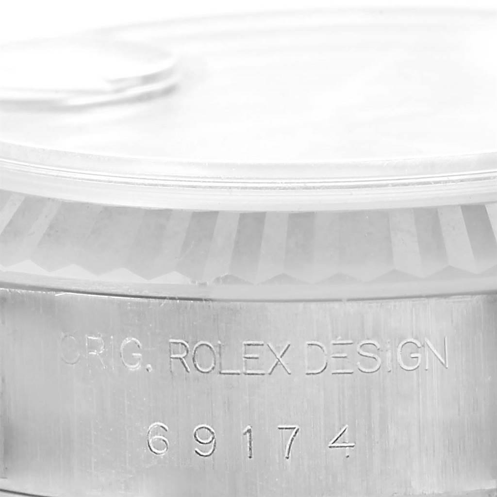 The image shows a close-up of the side of a Rolex Datejust 69174 Women's Stainless Steel Blue Dial 69174 Women's Stainless Steel Blue Dial watch's case, displaying the model number "69174" and "ORIG. ROLEX DESIGN."