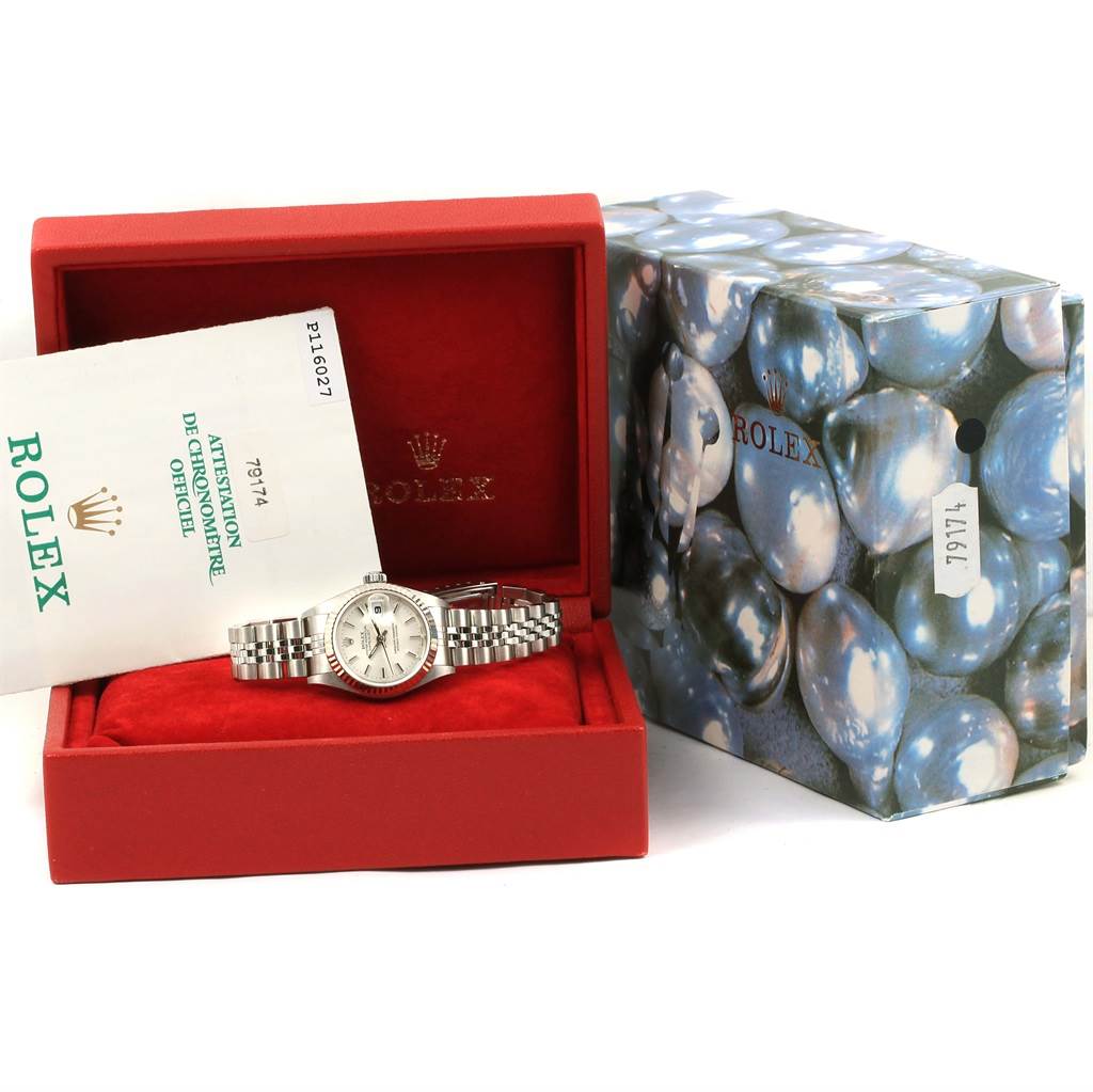 The image shows a Rolex Datejust 79174 Women
s Stainless Steel Silver Dial 79174 Women
s Stainless Steel Silver Dial watch placed in an open red box with its accessories and original packaging visible.