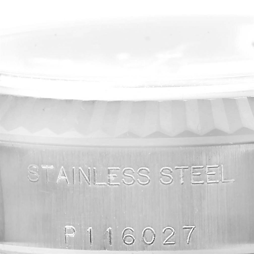 This image shows a close-up of the casing near the bezel of a Rolex Datejust 79174 Women
s Stainless Steel Silver Dial 79174 Women
s Stainless Steel Silver Dial watch, displaying the "STAINLESS STEEL" engraving.