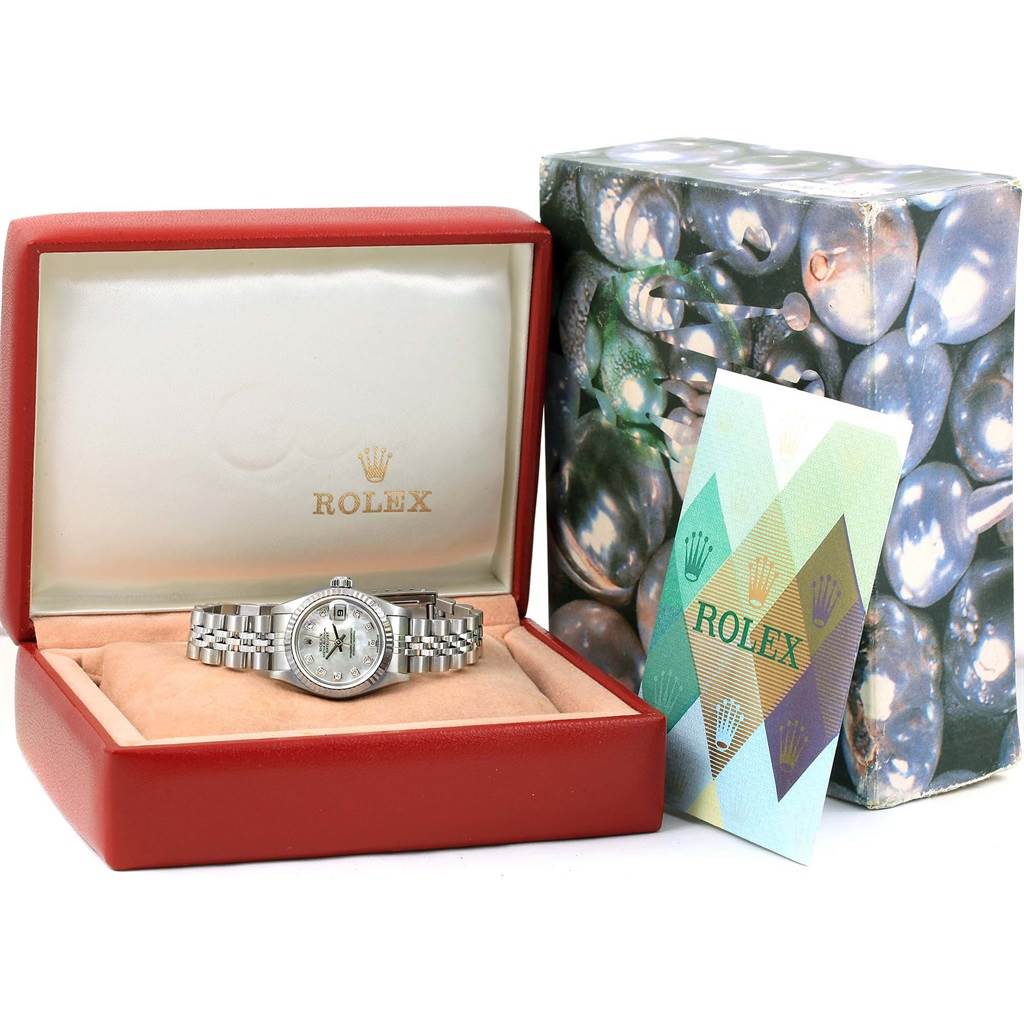 The Rolex Datejust 79174 Women's Stainless Steel Mother of Pearl Dial 79174 Women's Stainless Steel Mother of Pearl Dial watch is shown from the front, displayed in an open red box alongside its outer packaging and paperwork.