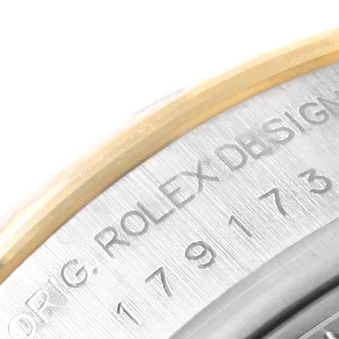 The image shows a close-up of the inner bezel with "Rolex Design" engraved on a Rolex Datejust 179173 Women's Steel and Gold (two tone) Blue Dial 179173 Women's Steel and Gold (two tone) Blue Dial watch.