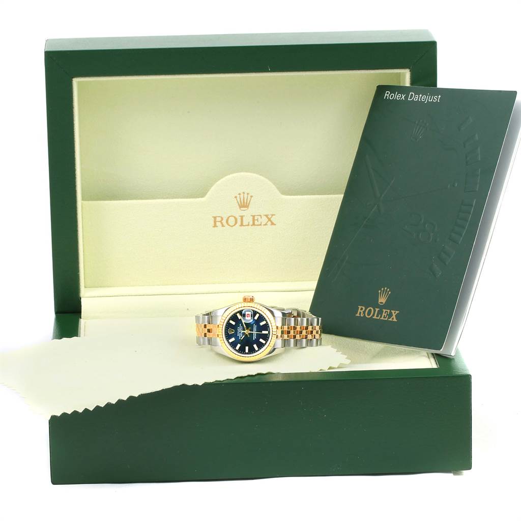 The photo shows a Rolex Datejust 179173 Women's Steel and Gold (two tone) Blue Dial 179173 Women's Steel and Gold (two tone) Blue Dial watch in an open box along with its instruction booklet.