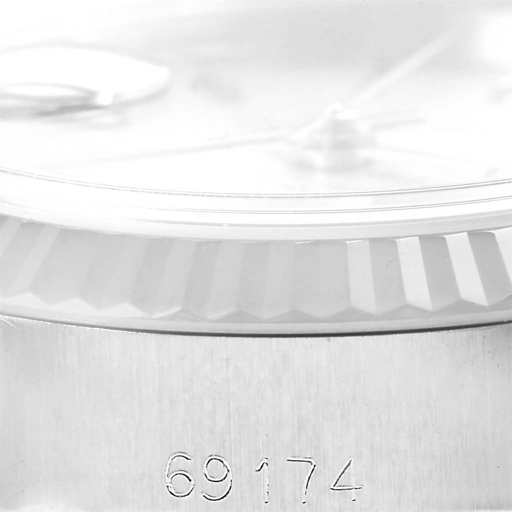 This image shows a close-up angle of the serial number area and fluted bezel of a Rolex Datejust 69174 Women's Stainless Steel Silver Dial 69174 Women's Stainless Steel Silver Dial watch.