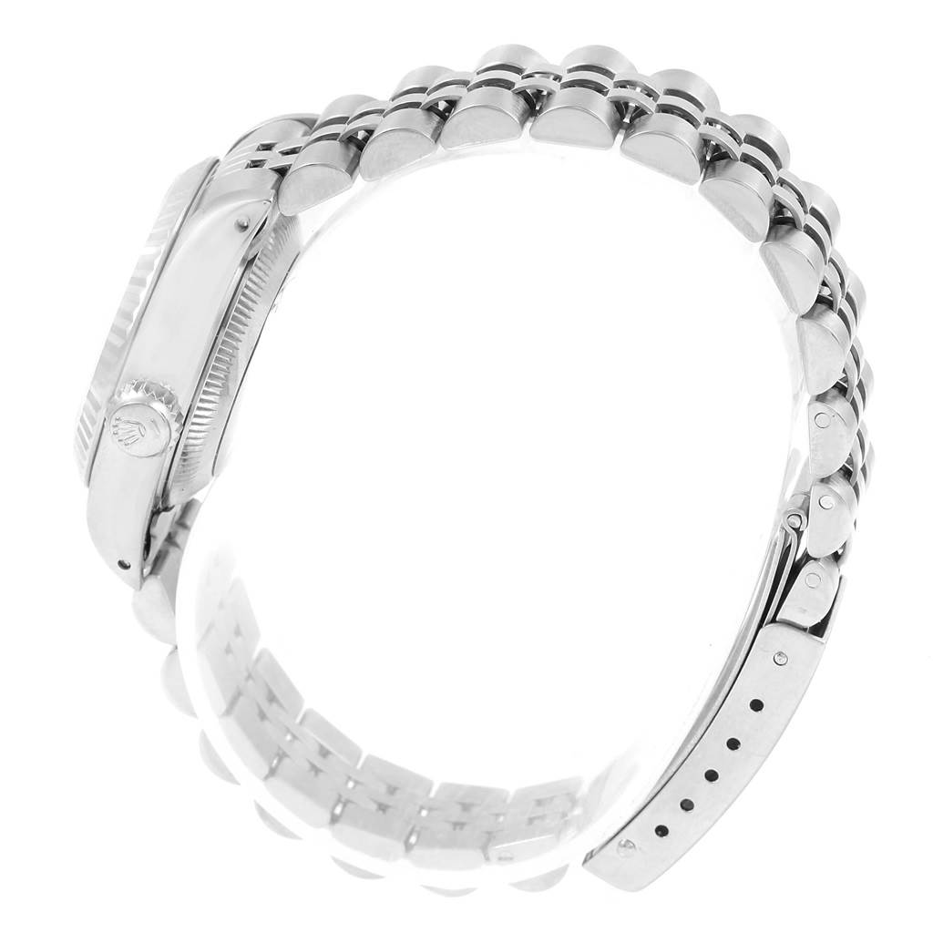 Side view of a Rolex Datejust 69174 Women's Stainless Steel Silver Dial 69174 Women's Stainless Steel Silver Dial watch showing the crown and part of the bracelet.