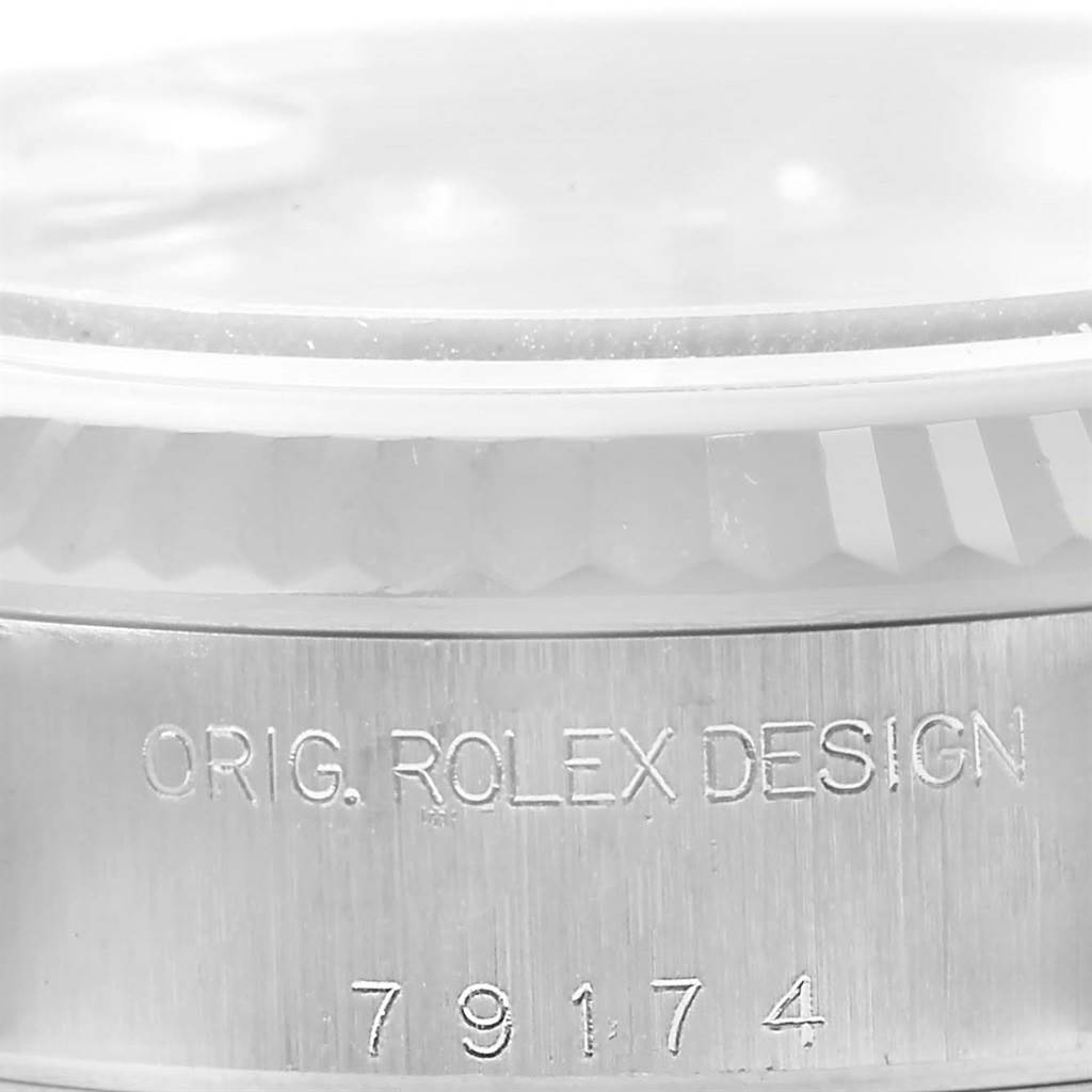 This image shows a close-up of the case side of a Rolex Datejust 79174 Women's Stainless Steel Silver Dial 79174 Women's Stainless Steel Silver Dial watch, highlighting the engraved serial number "79174" and "ORIG. ROLEX DESIGN."