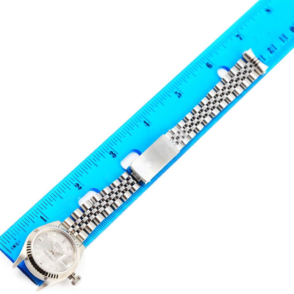 The image shows a Rolex Datejust 79174 Women's Stainless Steel Silver Dial 79174 Women's Stainless Steel Silver Dial watch laid flat, displaying the watch face, bracelet, and clasp next to a blue ruler for scale.