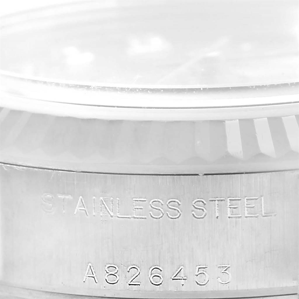 The image shows a close-up angle of the engraved stainless steel case of a Rolex Datejust 79174 Women's Stainless Steel Silver Dial 79174 Women's Stainless Steel Silver Dial watch.