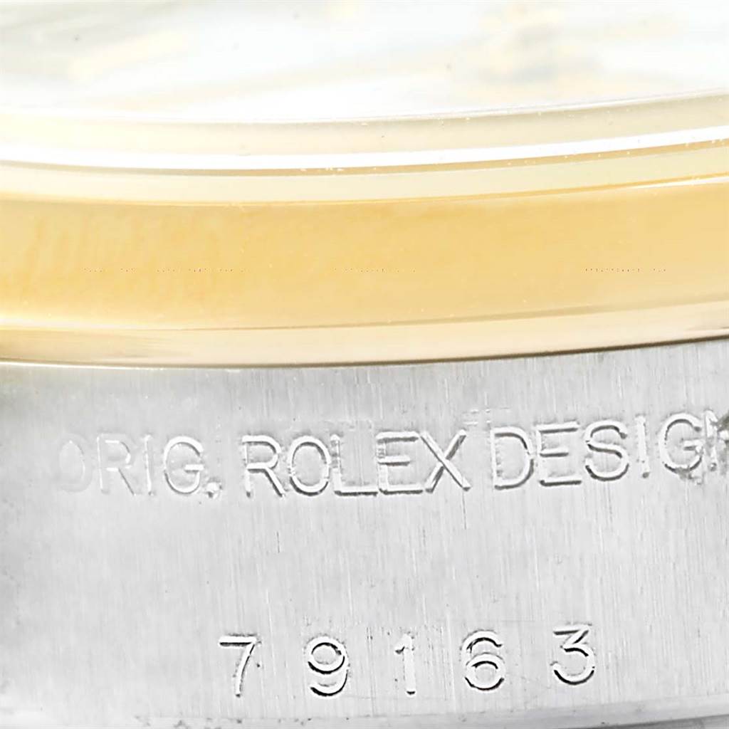 This close-up image shows the case side of a Rolex Datejust 79163 Women's Steel and Gold (two tone) White Dial 79163 Women's Steel and Gold (two tone) White Dial watch, featuring the brand engraving and model number.