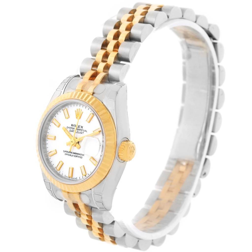The Rolex Datejust 179173 Women's Steel and Gold (two tone) White Dial 179173 Women's Steel and Gold (two tone) White Dial watch is shown from an angled side view, showcasing the face, fluted bezel, crown, and two-tone bracelet.