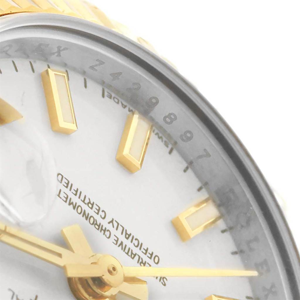 This close-up image of the Rolex Datejust 179173 Women's Steel and Gold (two tone) White Dial 179173 Women's Steel and Gold (two tone) White Dial watch shows part of the dial, hour markers, and second hand.