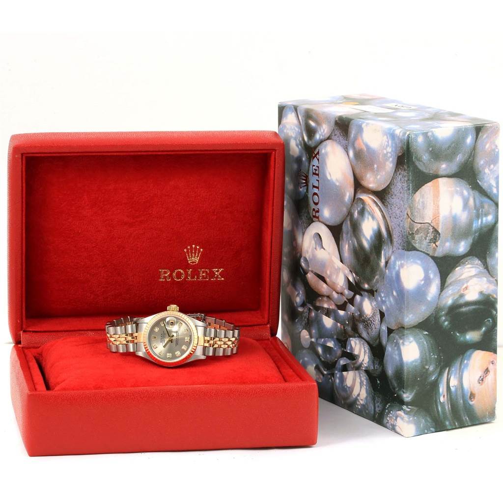 The Rolex Datejust 79173 Women's Stainless Steel Silver Dial 79173 Women's Stainless Steel Silver Dial watch is displayed front-facing in an open red box, with a patterned box in the background.