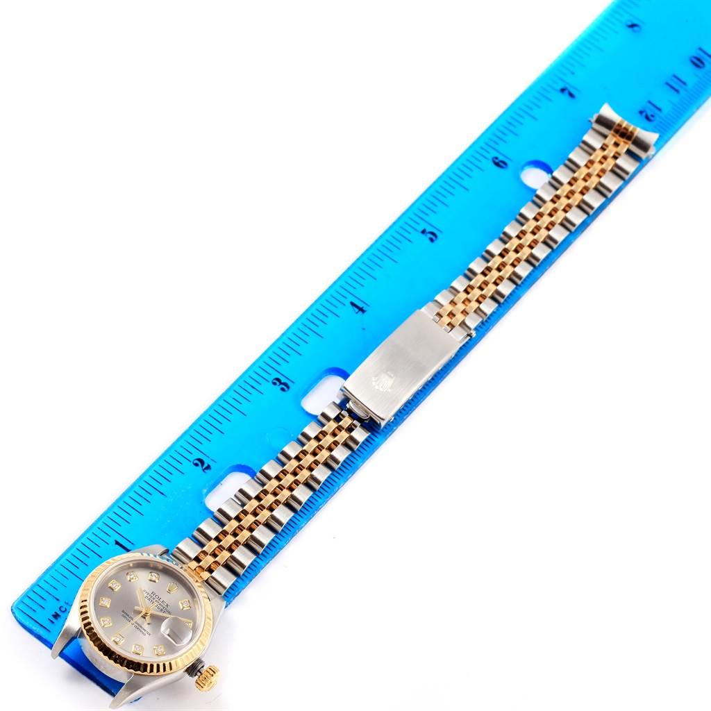 The image shows a Rolex Datejust 79173 Women's Stainless Steel Silver Dial 79173 Women's Stainless Steel Silver Dial watch with its full bracelet laid flat and measured against a blue ruler.