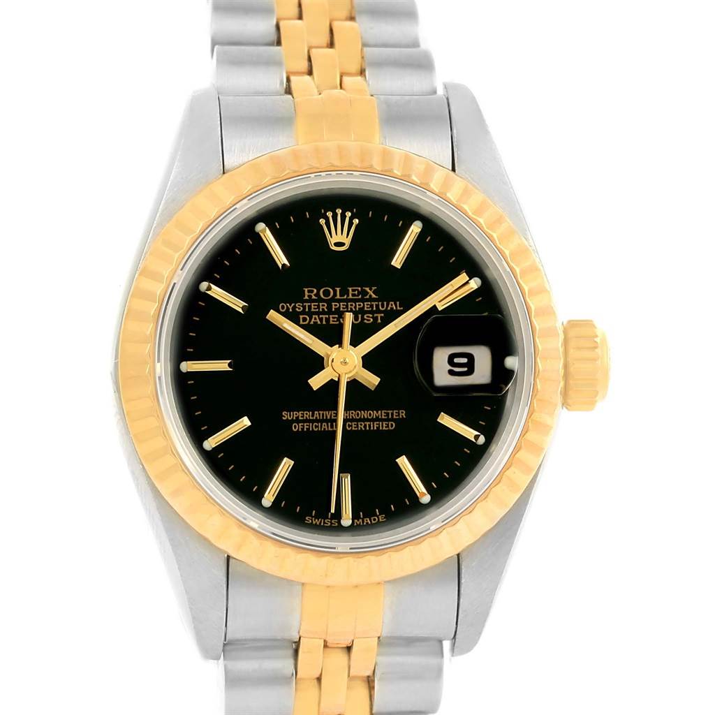This image shows a Rolex Datejust 79173 Women's Steel and Gold (two tone) Black Dial 79173 Women's Steel and Gold (two tone) Black Dial watch face with a gold bezel, black dial, date window, and two-tone metal bracelet.