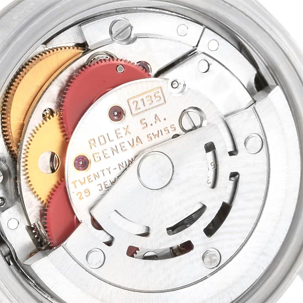 The image shows a close-up view of the Rolex Datejust 69240 Women's Stainless Steel Silver Dial 69240 Women's Stainless Steel Silver Dial model's movement, with visible gears and intricate mechanical parts.