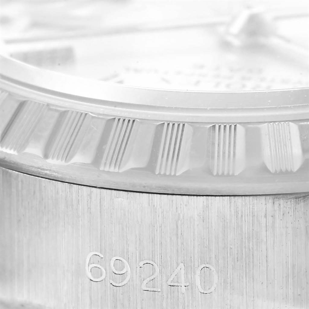 The image shows a close-up of the fluted bezel and serial number on the case of a Rolex Datejust 69240 Women's Stainless Steel Silver Dial 69240 Women's Stainless Steel Silver Dial watch.
