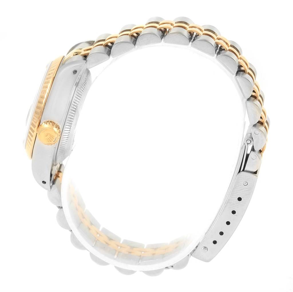 The Rolex Datejust 69173 Women's Stainless Steel Blue Dial 69173 Women's Stainless Steel Blue Dial watch is shown from a side angle, highlighting its gold fluted bezel and two-tone bracelet.