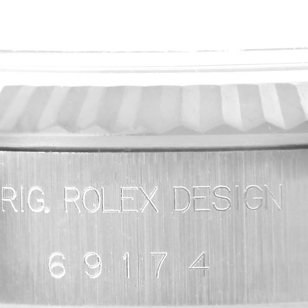 The image shows the side view of the case of a Rolex Datejust 69174 Women's Stainless Steel Silver Dial 69174 Women's Stainless Steel Silver Dial, featuring the model number 69174 and "ORIG. ROLEX DESIGN" engraving.