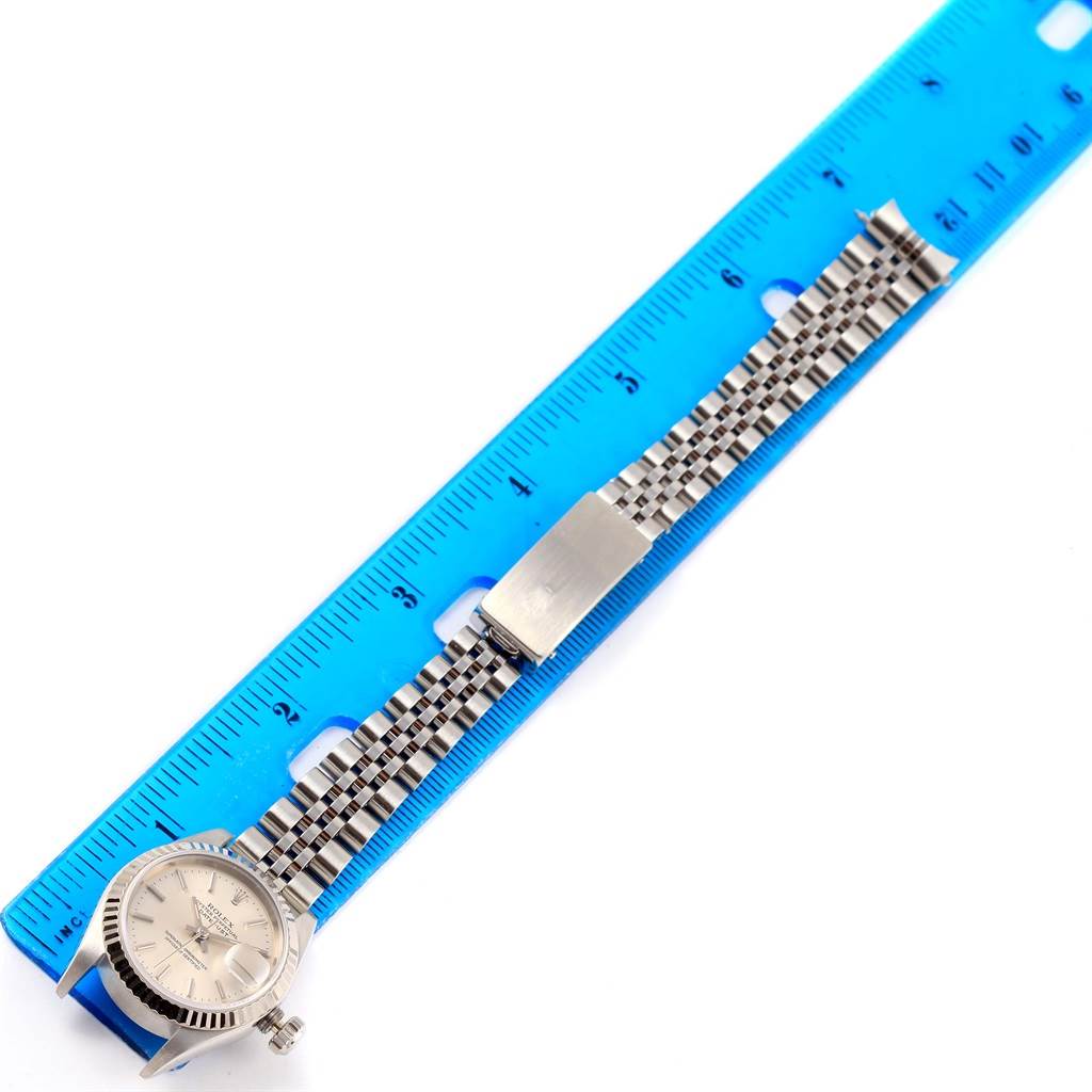 The image shows a Rolex Datejust 69174 Women's Stainless Steel Silver Dial 69174 Women's Stainless Steel Silver Dial watch laying flat next to a blue ruler, displaying the bracelet and clasp.