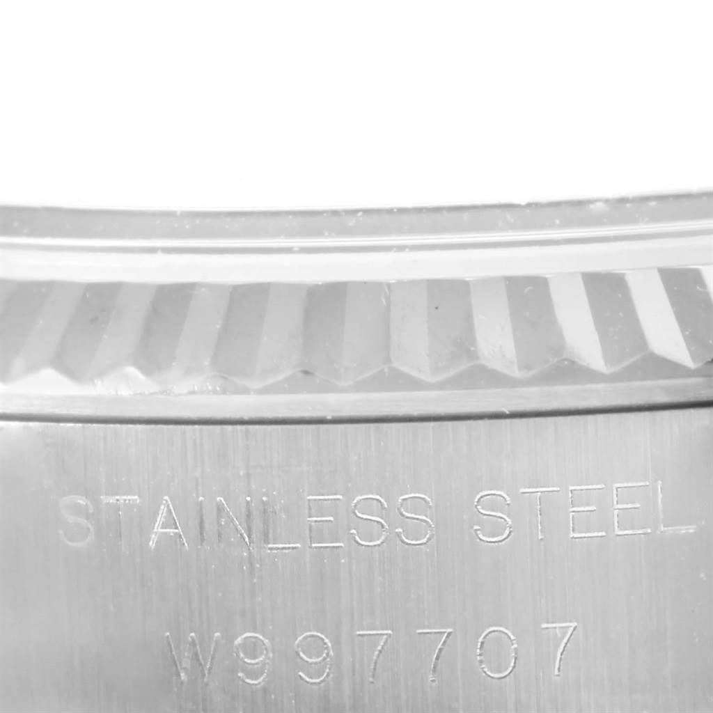 The image shows a close-up of the fluted bezel and engraved stainless steel casing of the Rolex Datejust 69174 Women's Stainless Steel Silver Dial 69174 Women's Stainless Steel Silver Dial watch.