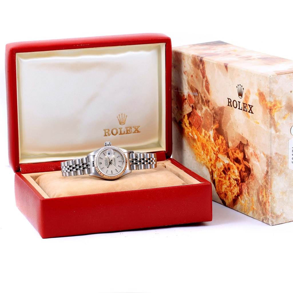 The image shows a Rolex Datejust 69174 Women's Stainless Steel Silver Dial 69174 Women's Stainless Steel Silver Dial watch in its box, with the face, bezel, and jubilee bracelet visible, next to Rolex packaging.