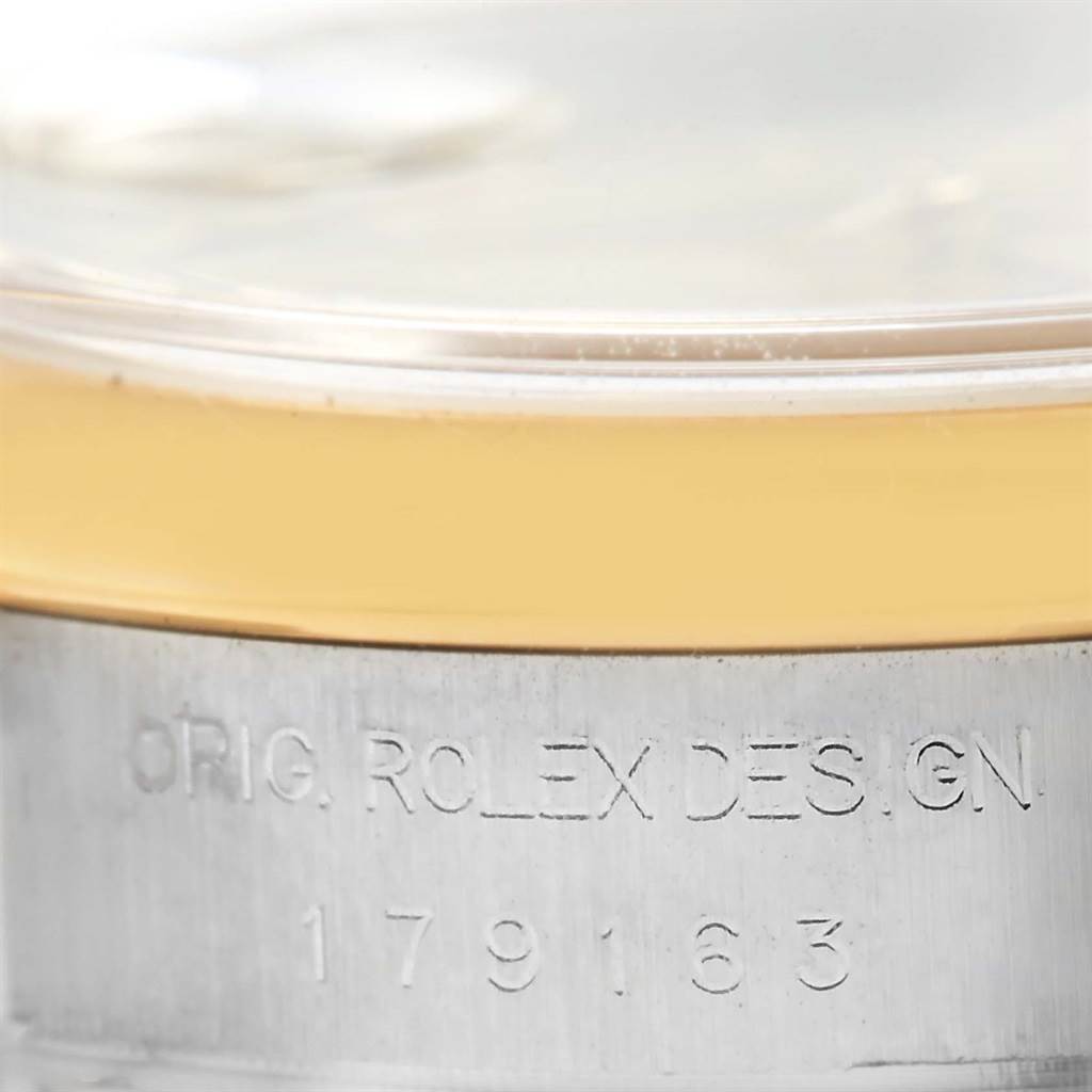 The image shows a close-up of the bezel and part of the case of a Rolex Datejust 179163 Women's Stainless Steel Mother of Pearl Dial 179163 Women's Stainless Steel Mother of Pearl Dial watch, including the engraved serial number.