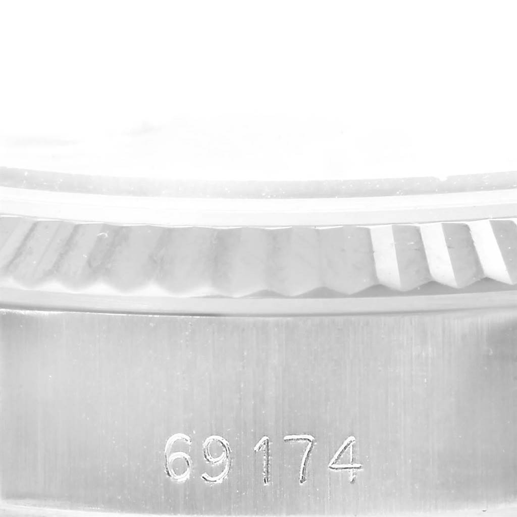 This image shows a close-up side view of the bezel and case of a Rolex Datejust 69174 Women's Stainless Steel Silver Dial 69174 Women's Stainless Steel Silver Dial watch, with the model number 69174 engraved.