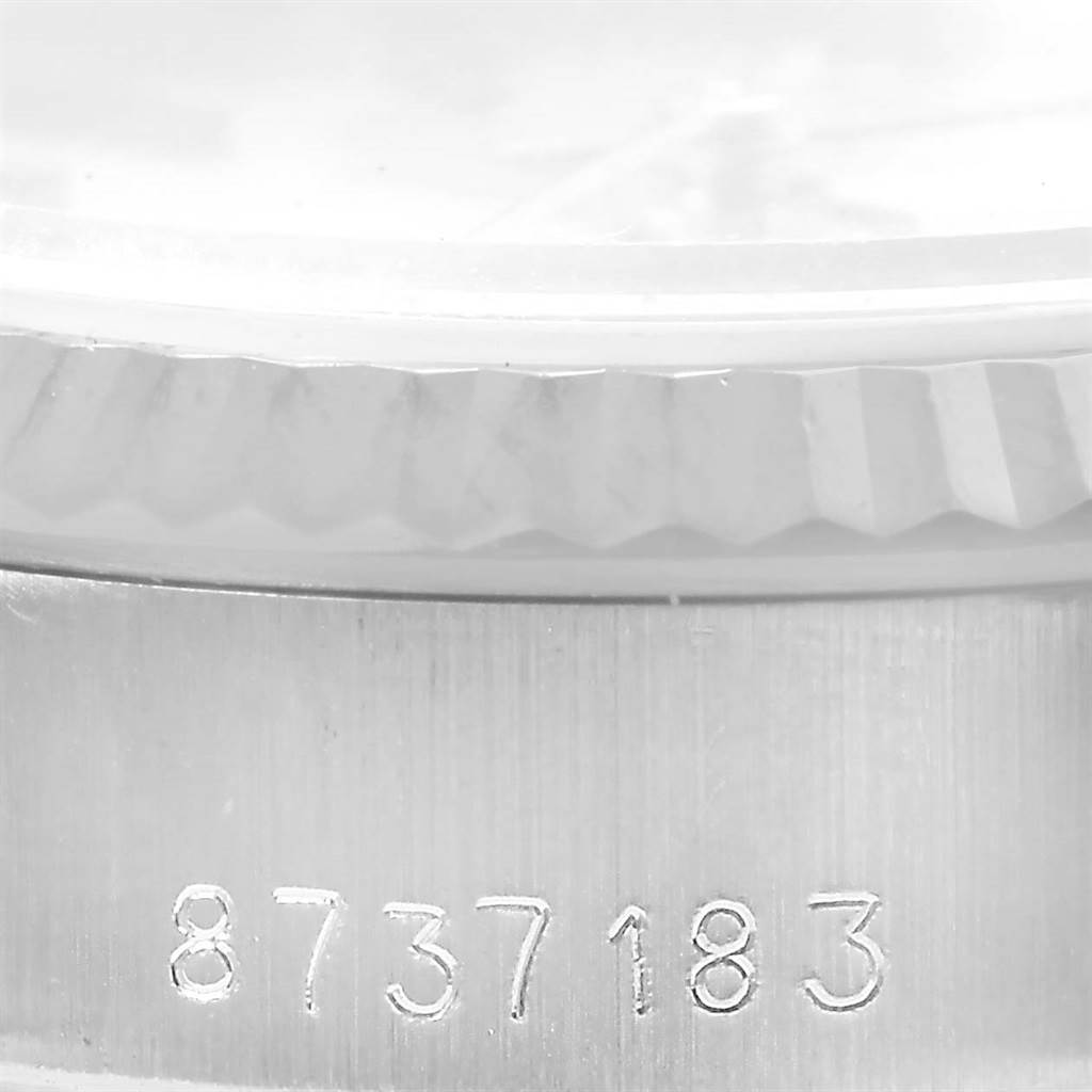 The image shows a close-up of the side of a Rolex Datejust 69174 Women's Stainless Steel Silver Dial 69174 Women's Stainless Steel Silver Dial watch, highlighting the serial number engraving and the edge of the bezel.