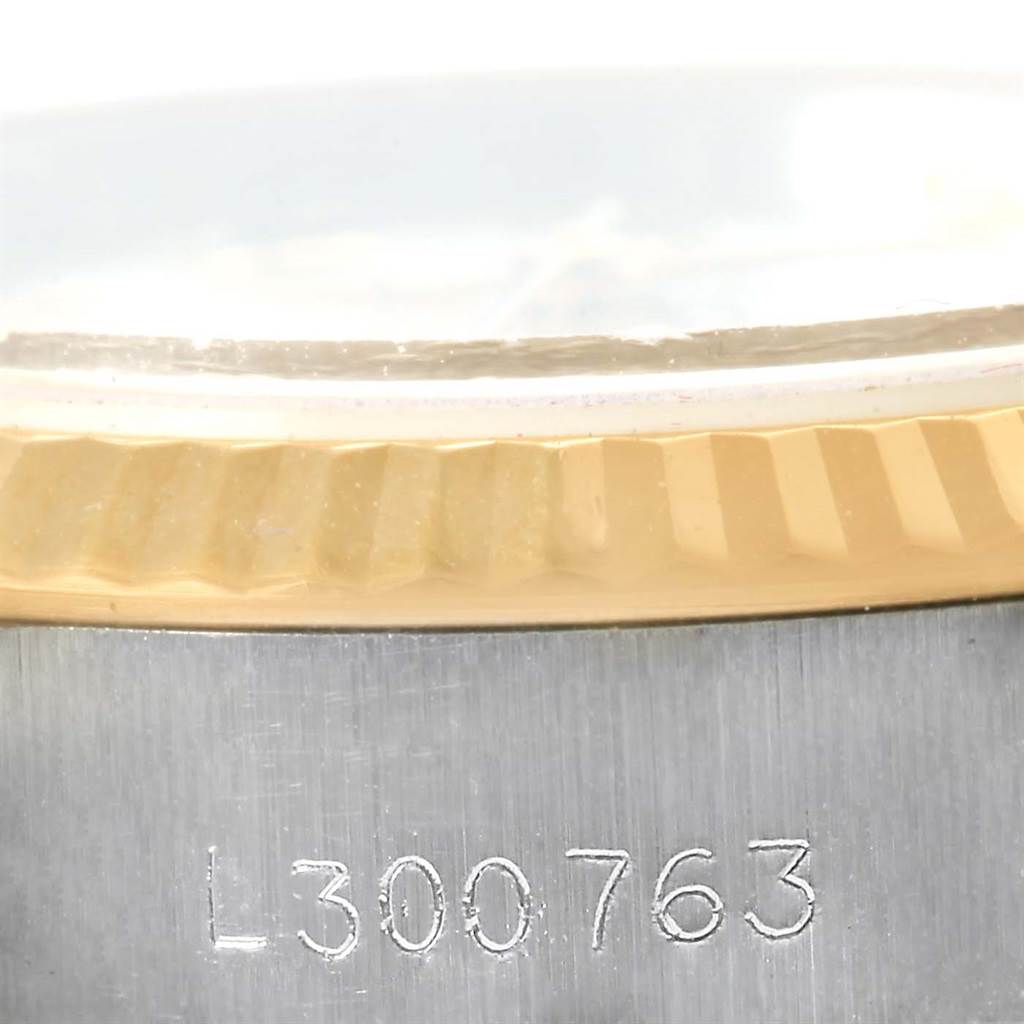 The image shows a close-up of the serial number and the fluted bezel of the Rolex Datejust 69173 Women's Stainless Steel Beige Dial 69173 Women's Stainless Steel Beige Dial model.