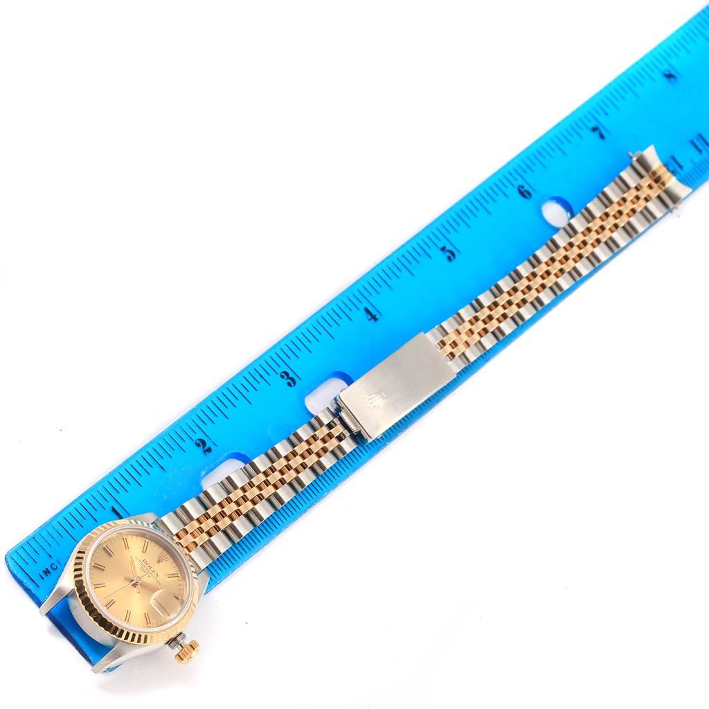 The image shows a Rolex Datejust 69173 Women's Stainless Steel Champagne Dial 69173 Women's Stainless Steel Champagne Dial watch laid flat beside a ruler, highlighting the watch face, bracelet, and clasp.