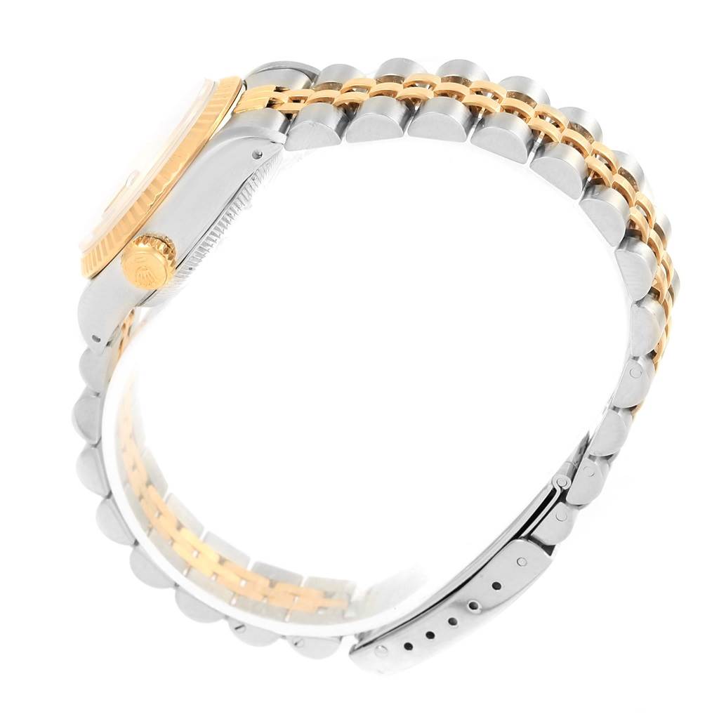 This is a side view of a Rolex Datejust 69173 Women's Stainless Steel Champagne Dial 69173 Women's Stainless Steel Champagne Dial watch showing the crown, bezel, and two-tone bracelet.