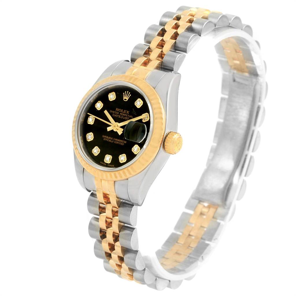 The image shows a Rolex Datejust 179173 Women
s Steel and Gold (two tone) Black Dial 179173 Women
s Steel and Gold (two tone) Black Dial watch at a three-quarter angle, highlighting its face, bezel, crown, and two-tone bracelet.