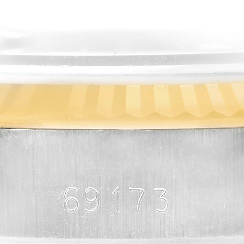 The image shows a close-up of the side of a Rolex Datejust 69173 Women's Stainless Steel Brown Dial 69173 Women's Stainless Steel Brown Dial watch with the model number 69173 engraved on the case.