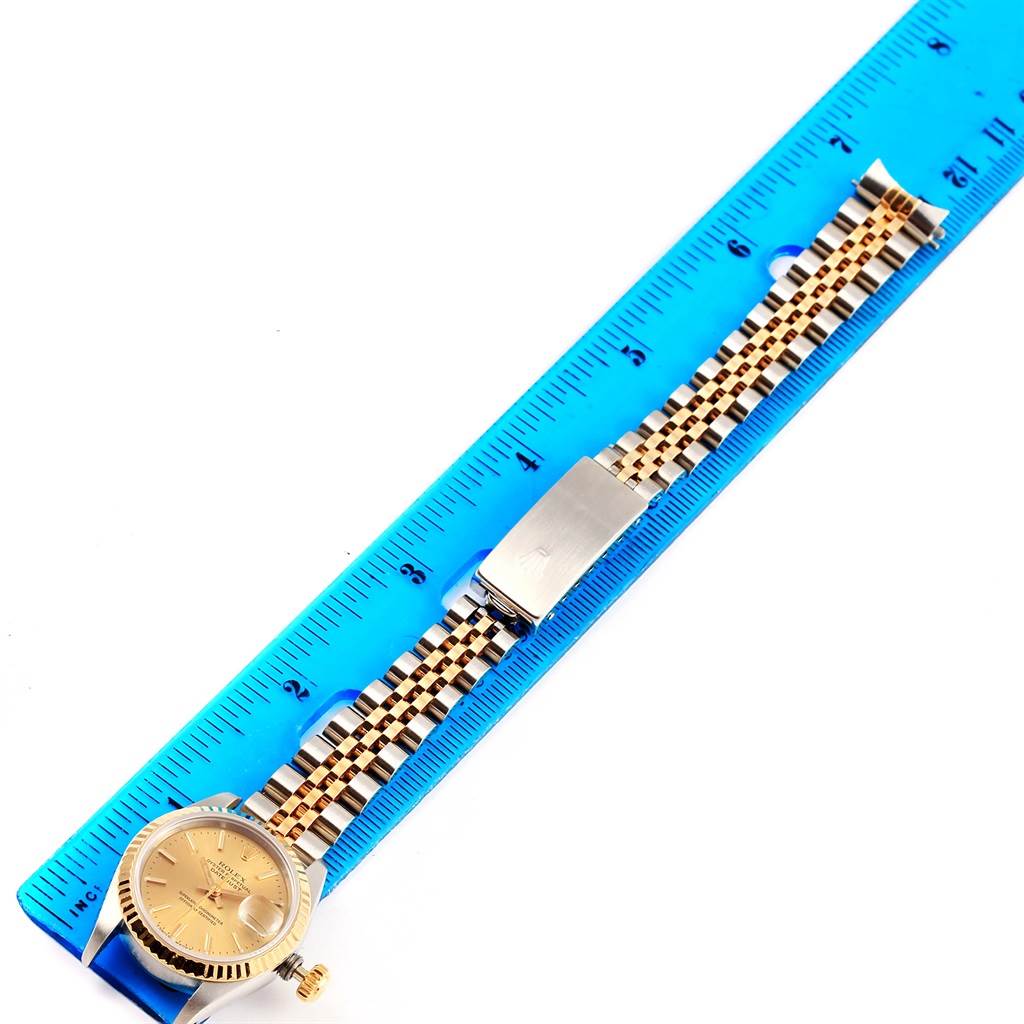 The image shows a Rolex Datejust 69173 Women's Stainless Steel Champagne Dial 69173 Women's Stainless Steel Champagne Dial watch laid flat next to a blue ruler, showcasing the watch face and band.