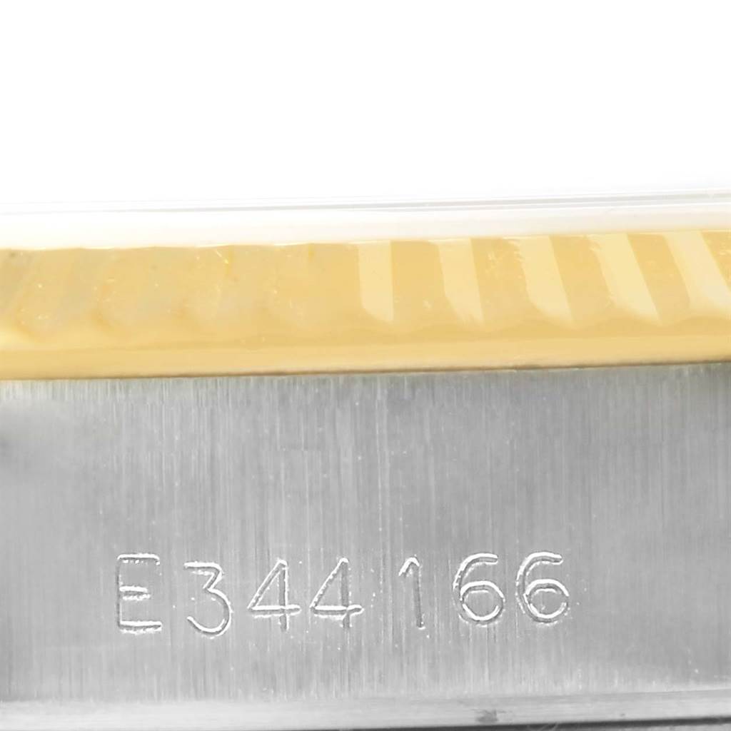 The image shows a close-up of the serial number and fluted bezel of a Rolex Datejust 69173 Women's Stainless Steel Champagne Dial 69173 Women's Stainless Steel Champagne Dial watch.