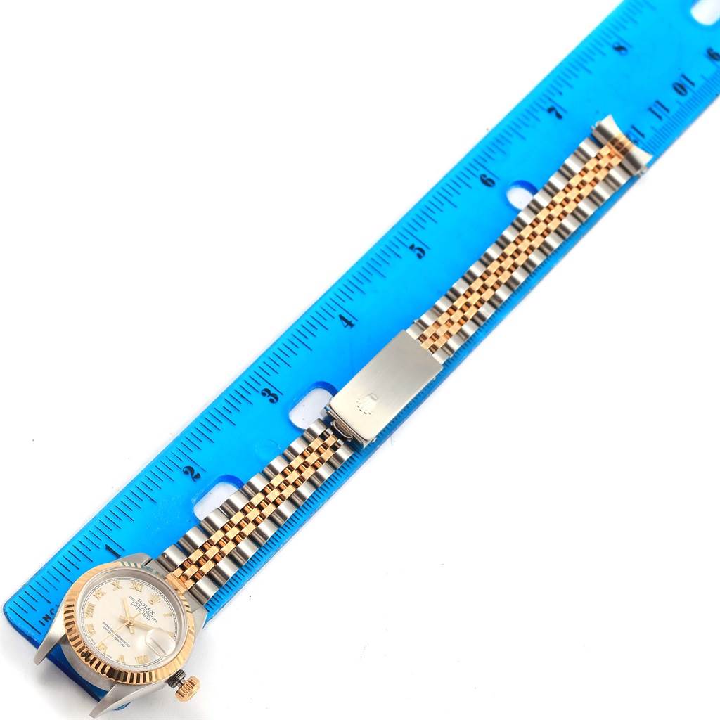 The image shows a Rolex Datejust 69173 Women's Stainless Steel Beige Dial 69173 Women's Stainless Steel Beige Dial watch laid flat alongside a blue ruler for measurement, showcasing its bracelet and dial.