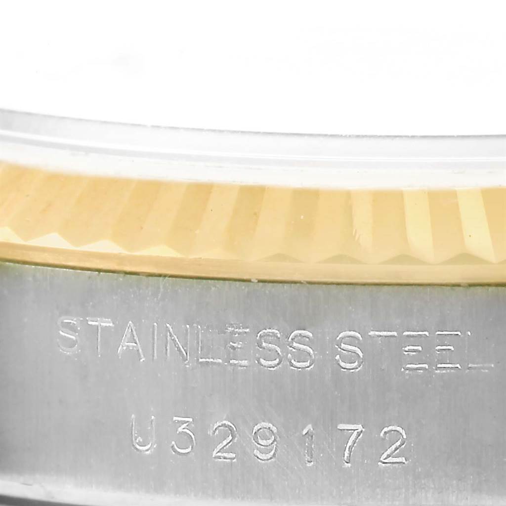 This close-up image shows the bezel, the rehaut, and serial number engraving on the stainless steel of a Rolex Datejust 69173 Women's Stainless Steel Beige Dial 69173 Women's Stainless Steel Beige Dial watch.