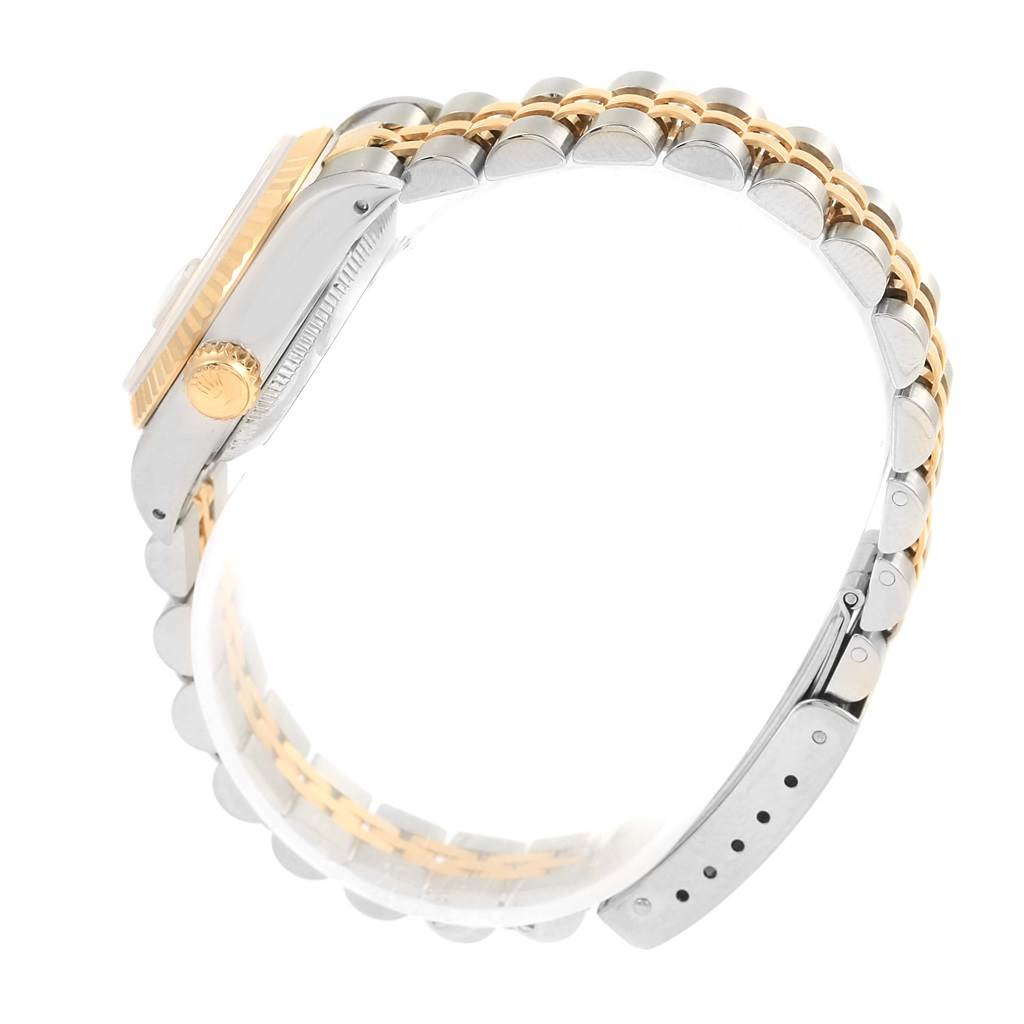 This side angle view of the Rolex Datejust 69173 Women's Stainless Steel Black Dial 69173 Women's Stainless Steel Black Dial watch showcases the case, crown, and two-tone bracelet.