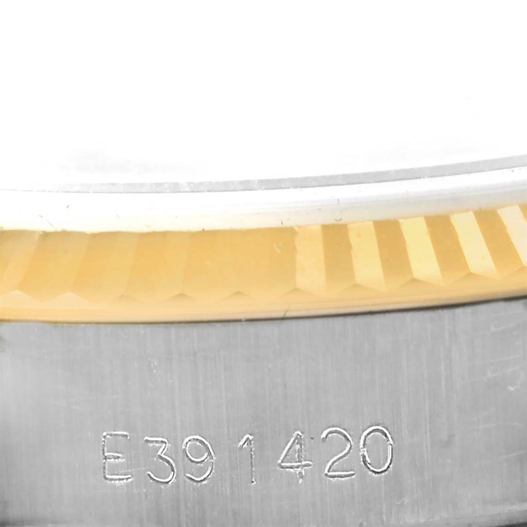 This close-up image shows part of the bezel and case with a serial number of a Rolex Datejust 69173 Women's Stainless Steel Black Dial 69173 Women's Stainless Steel Black Dial watch.