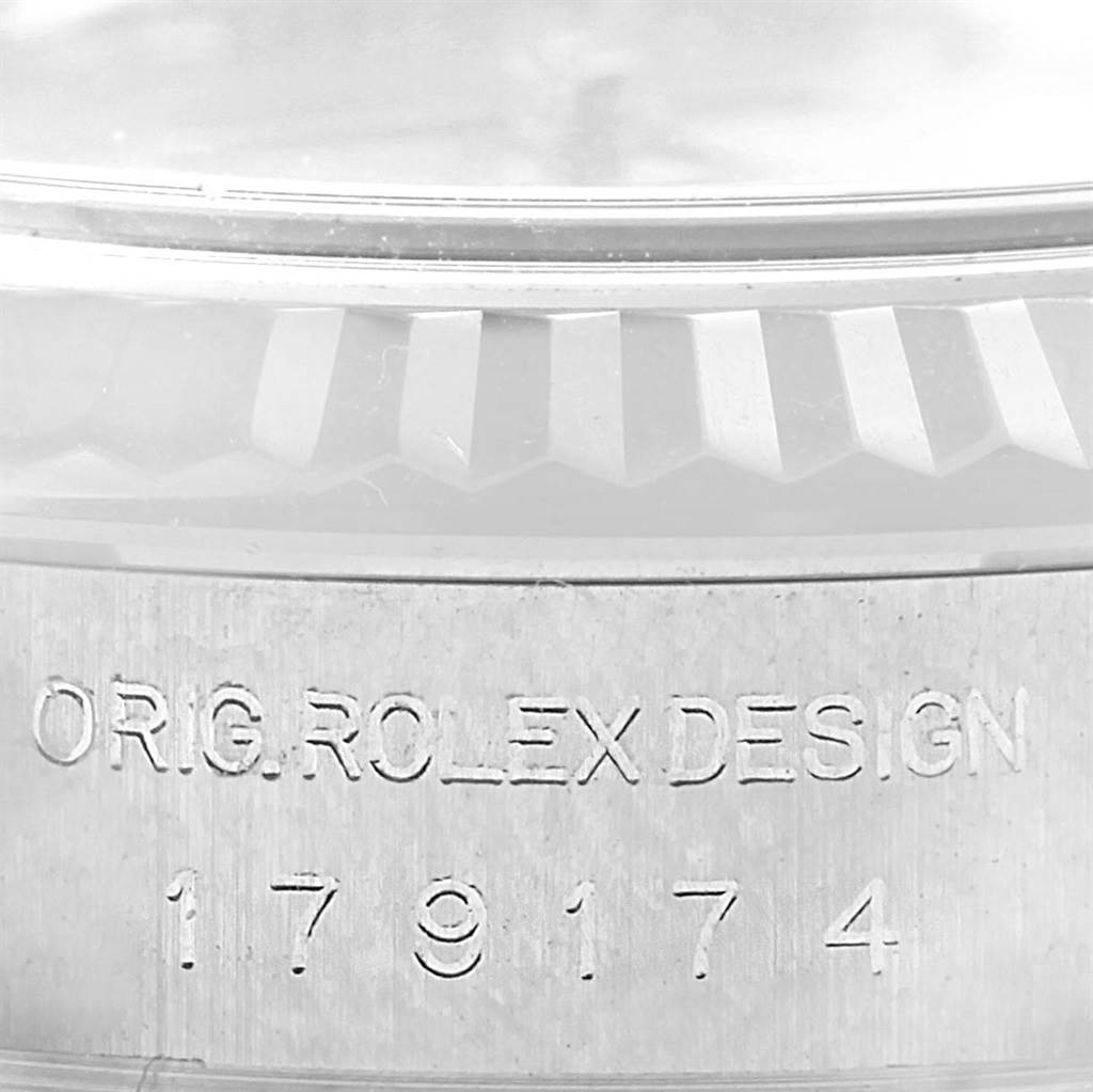 The image shows an engraving on the case side of the Rolex Datejust 179174 Women's Stainless Steel Pink Dial 179174 Women's Stainless Steel Pink Dial watch, displaying "ORIG.ROLEX DESIGN" and the model number.