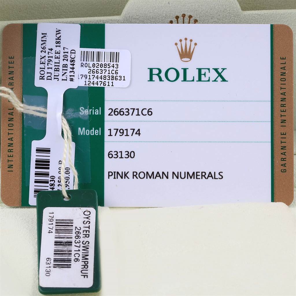 This image shows a warranty card and a tag for the Rolex Datejust 179174 Women's Stainless Steel Pink Dial 179174 Women's Stainless Steel Pink Dial model 179174 with serial number 266371C6.