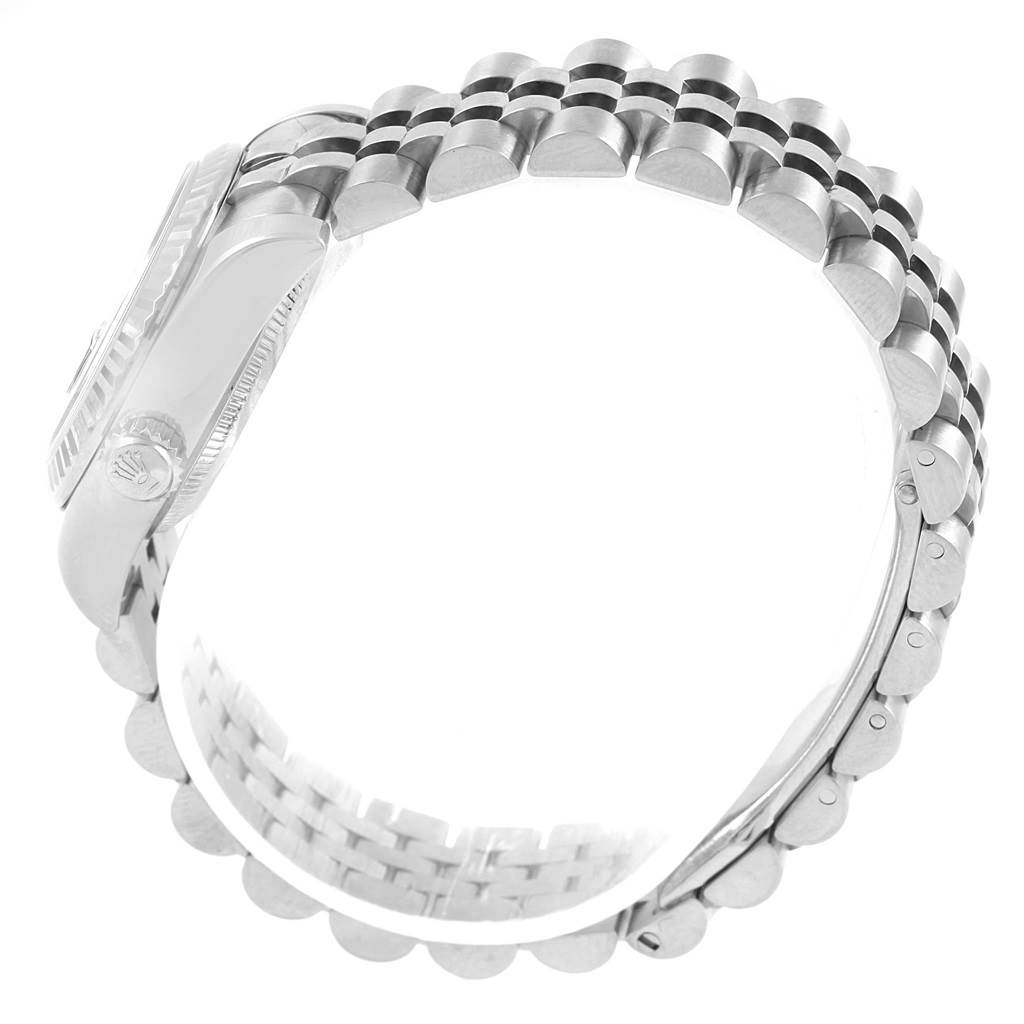 This is a side view of the Rolex Datejust 179174 Women's Stainless Steel Black Dial 179174 Women's Stainless Steel Black Dial showing its Jubilee bracelet and the edge of the watch case.