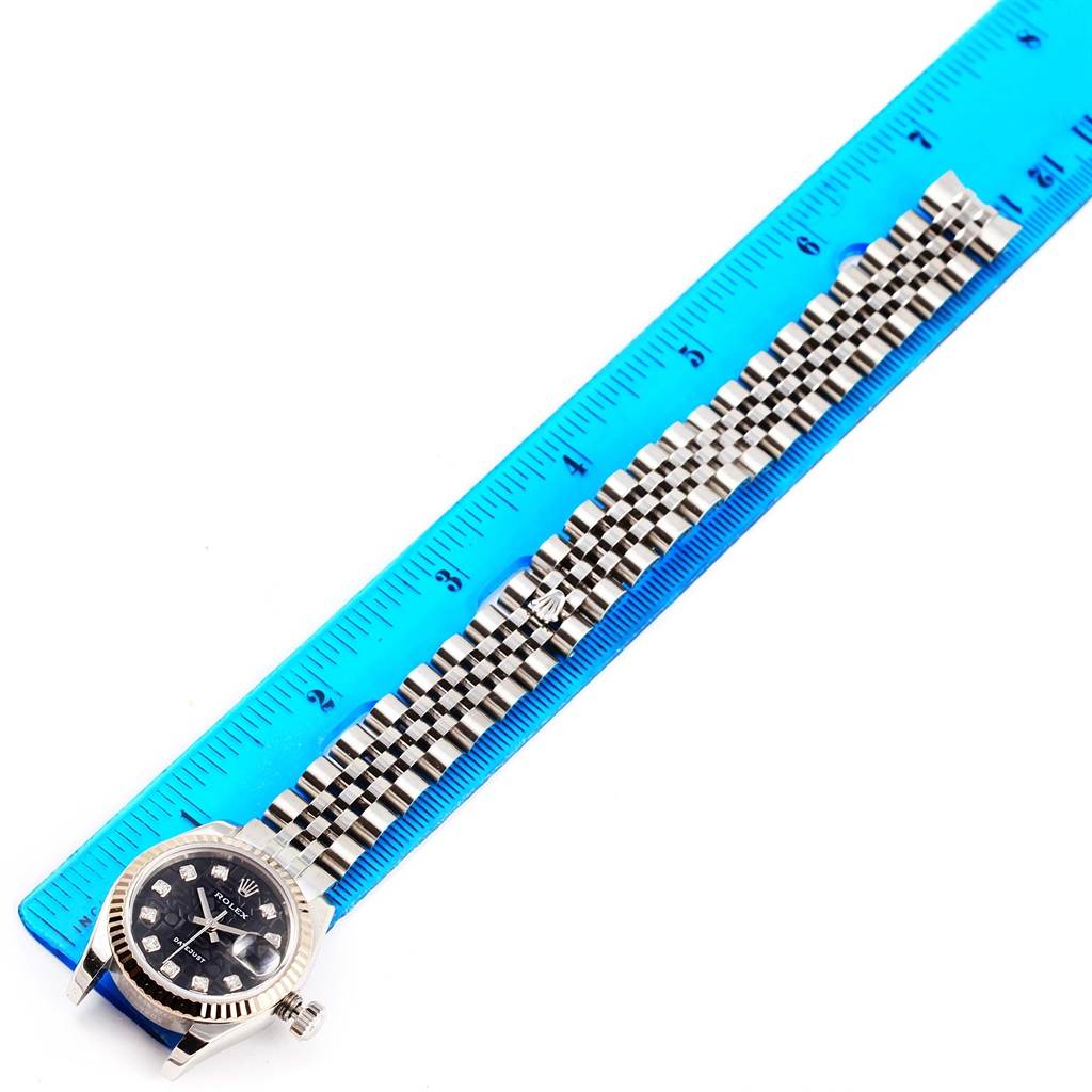 The image shows a Rolex Datejust 179174 Women's Stainless Steel Black Dial 179174 Women's Stainless Steel Black Dial watch placed alongside a blue ruler, displaying the watch face and bracelet in a top-down view.