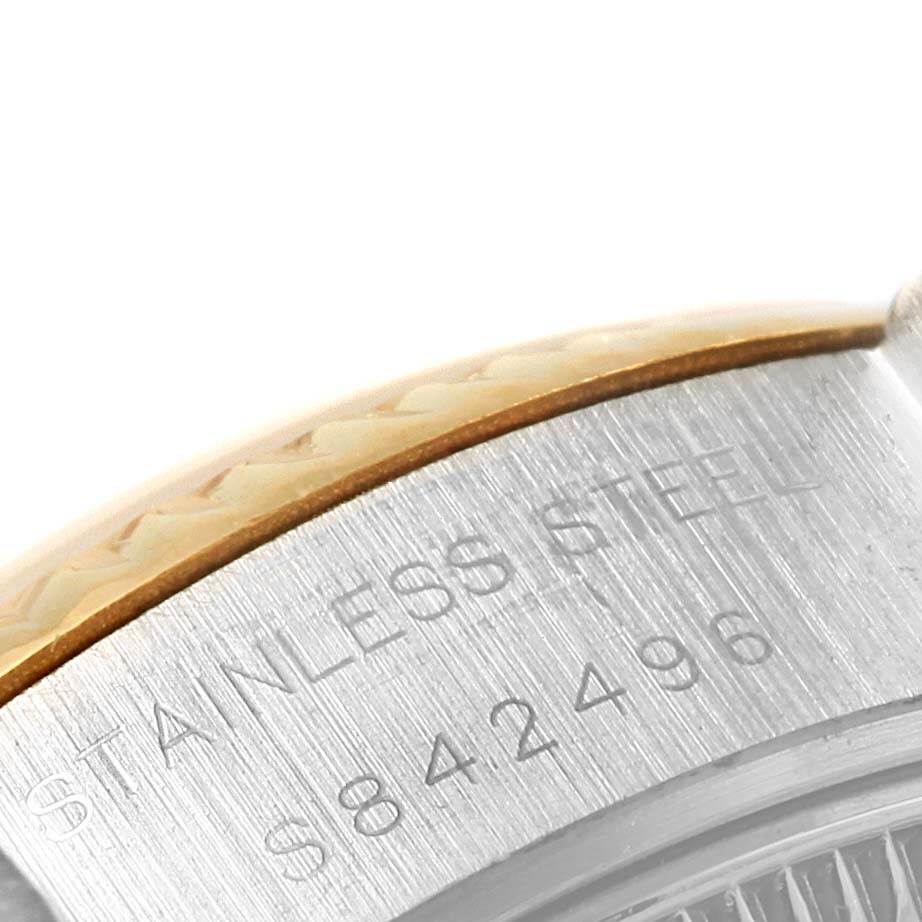 This image shows a close-up of the serial number and the stainless steel part of the bezel on a Rolex Datejust 69173 Women's Stainless Steel Champagne Dial 69173 Women's Stainless Steel Champagne Dial watch.