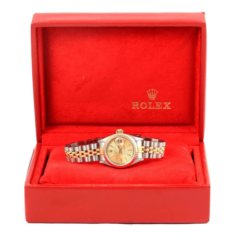 The Rolex Datejust 69173 Women's Stainless Steel Champagne Dial 69173 Women's Stainless Steel Champagne Dial watch is presented front-facing in a red box with a metal bracelet and a gold dial.